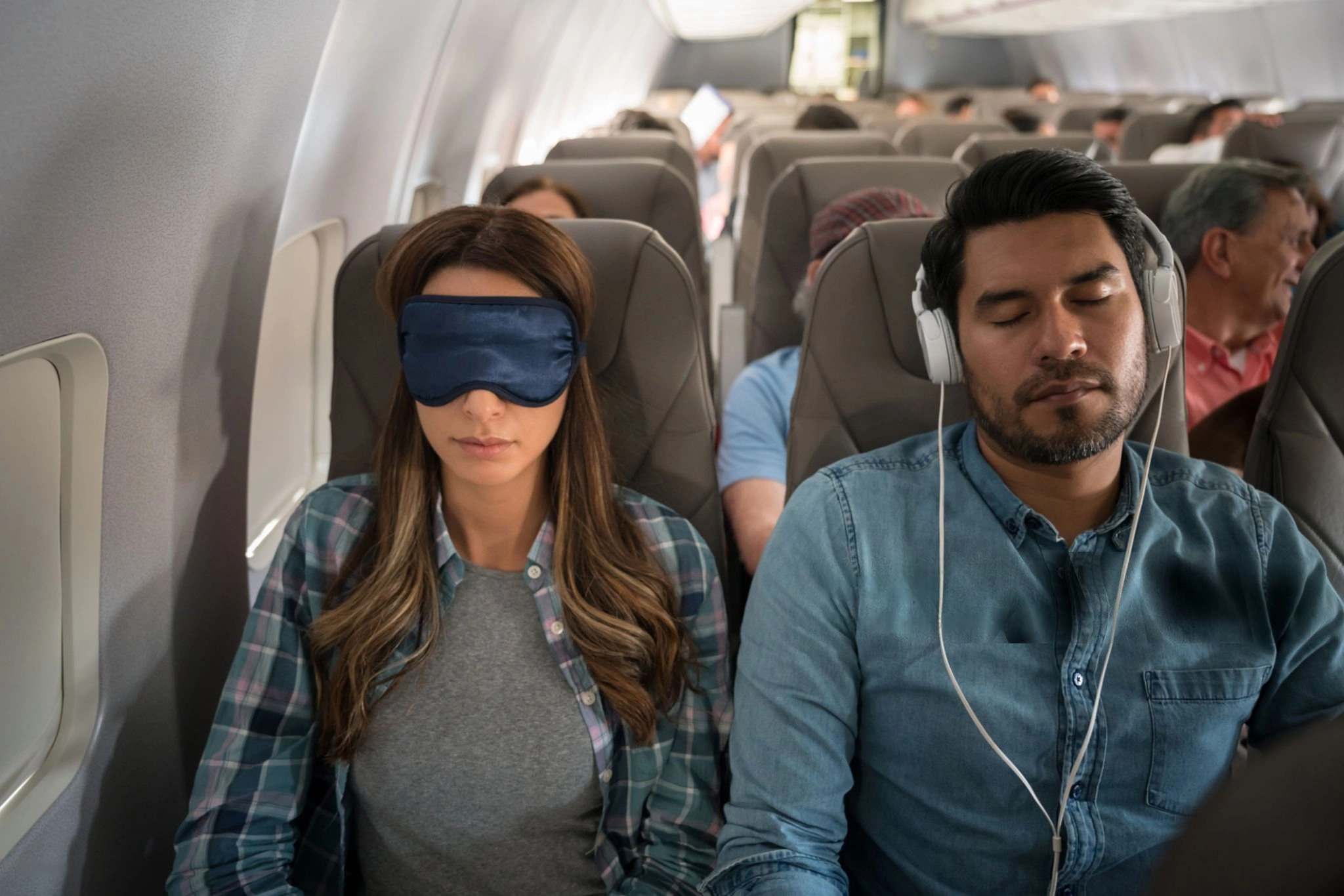 Travelers sleeping on plane going from Mexico to the UK